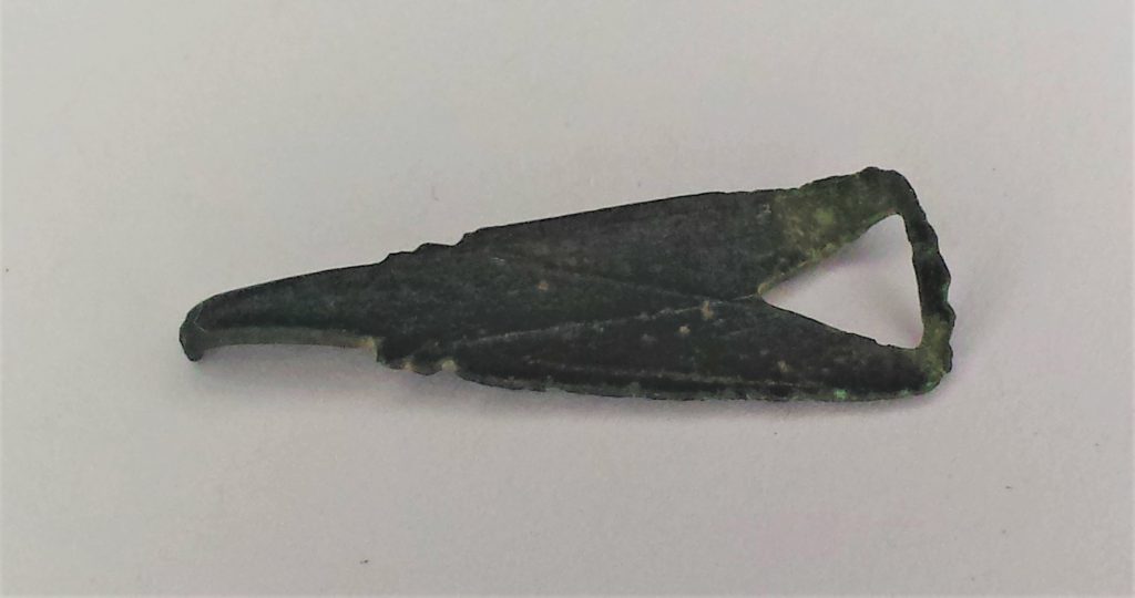 Early medieval bronze clothing fastener with simple linear decoration. 12th - 13th Century CE.